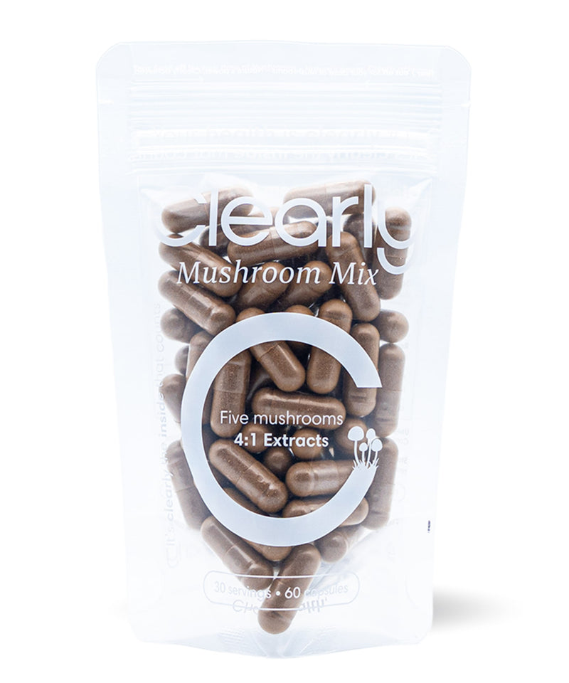 Clearly Mushroom Mix capsules in a bottle with a label showing various mushroom illustrations, front view.